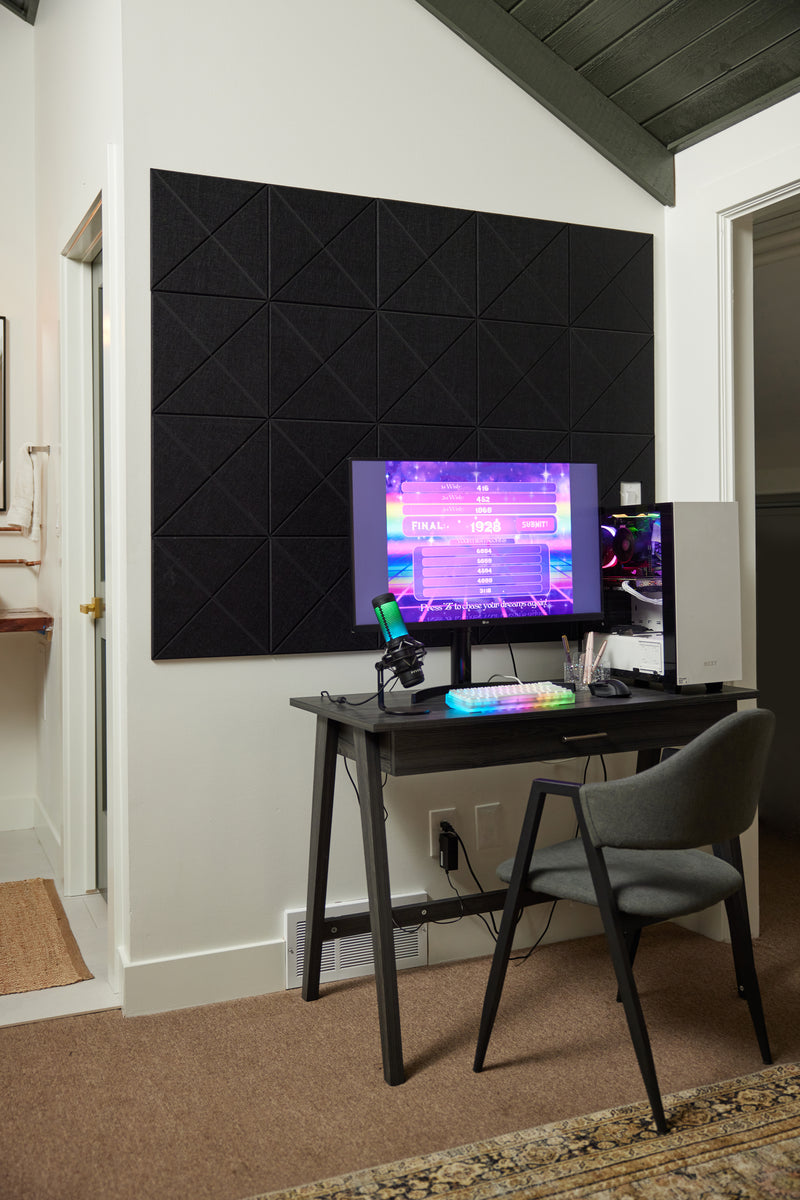 A Felt Right wall art design in the shade of black on a white wall behind a desk with a computer