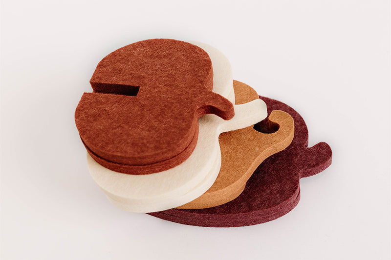 Set of four felt pumpkins in different colors on a white background