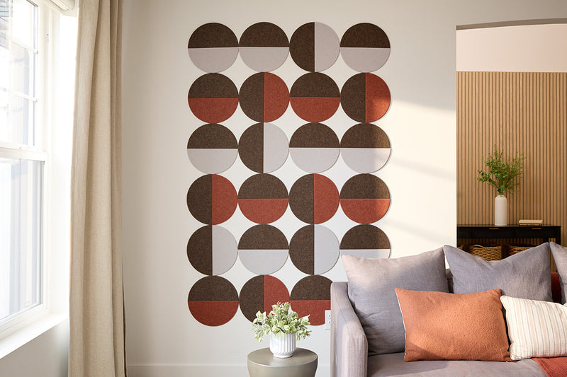 A Felt Right Design on a wall featuring a geometric pattern of circular tiles in shades of brown, gray, and white. Modern look for an entry way or living room space