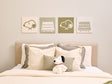Bedroom with Snoopy plush toy and decorative pillows on a bed, featuring Snoopy illustrations on the wall.