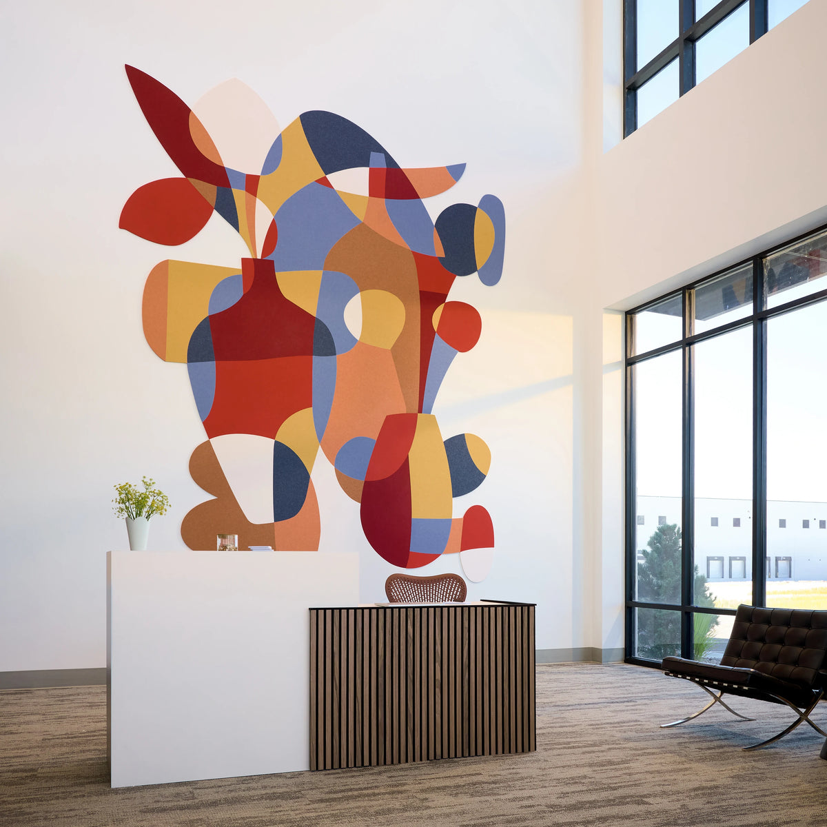 Teresa Rego Garden Party felt mural in a lobby