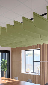 Light green acoustic ceiling blade baffles suspended from the ceiling, installed in a conference room. Felt Right's acoustic blade baffles absorb 65% of sound waves, making office spaces quieter and feel more calm.