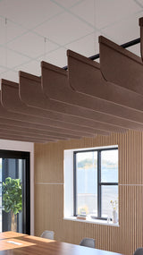 Brown acoustic ceiling blade baffles suspended from the ceiling, installed in a conference room. Felt Right's acoustic blade baffles absorb 65% of sound waves, making office spaces quieter and feel more calm.