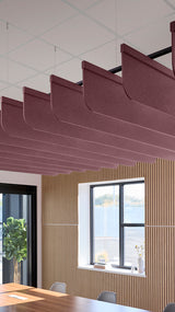Deep reddish-purple acoustic ceiling blade baffles suspended from the ceiling, installed in a conference room. Felt Right's acoustic blade baffles absorb 65% of sound waves, making office spaces quieter and feel more calm.