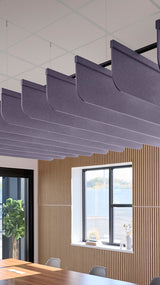 Soft violet acoustic ceiling blade baffles suspended from the ceiling, installed in a conference room. Felt Right's acoustic blade baffles absorb 65% of sound waves, making office spaces quieter and feel more calm.