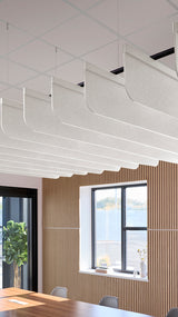 White acoustic ceiling blade baffles suspended from the ceiling, installed in a conference room. Felt Right's acoustic blade baffles absorb 65% of sound waves, making office spaces quieter and feel more calm.