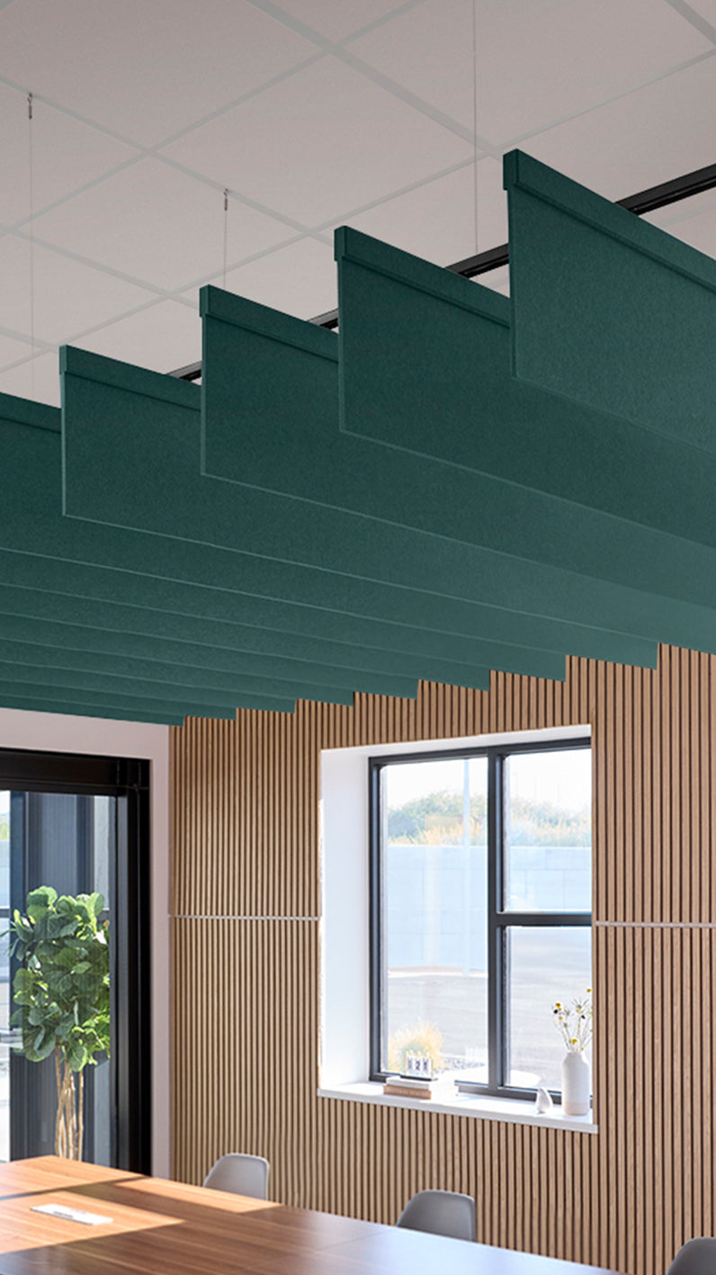 Blue-green acoustic ceiling blade baffles suspended from the ceiling, installed in a conference room. Felt Right's acoustic blade baffles absorb 65% of sound waves, making office spaces quieter and feel more calm.