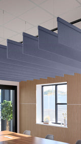 Indigo blue acoustic ceiling blade baffles suspended from the ceiling, installed in a conference room. Felt Right's acoustic blade baffles absorb 65% of sound waves, making office spaces quieter and feel more calm.