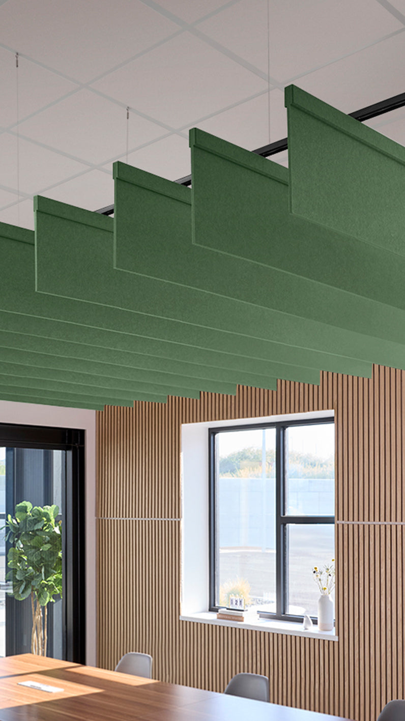 Green acoustic ceiling blade baffles suspended from the ceiling, installed in a conference room. Felt Right's acoustic blade baffles absorb 65% of sound waves, making office spaces quieter and feel more calm.