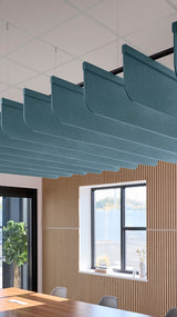 Teal fabric acoustic baffles suspended from ceiling with black metal rails in modern office space.