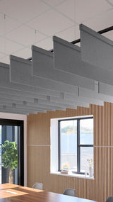 Gray fabric acoustic baffles suspended from ceiling with black mounting hardware in modern office space.