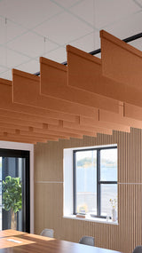 Terracotta acoustic baffles suspended from ceiling above vertical wood slat wall panels in modern office space.