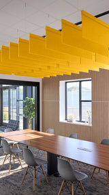 Yellow straight acoustic baffles suspended from ceiling in modern office conference room with wooden table and chairs.