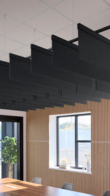 Black rectangular acoustic baffles suspended from ceiling above wooden wall paneling in modern office space.