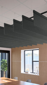 Dark gray rectangular acoustic baffles suspended horizontally from ceiling in modern office space with wood paneling and wind
