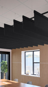 Four black straight acoustic blade baffles suspended from ceiling above wooden slat wall in modern interior space.