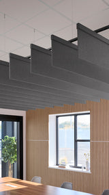 Dark gray fabric acoustic baffles suspended horizontally from ceiling in modern office space.