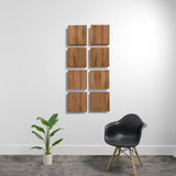 Eight wood-grain acoustic panels arranged in a 2x4 grid on a white wall.