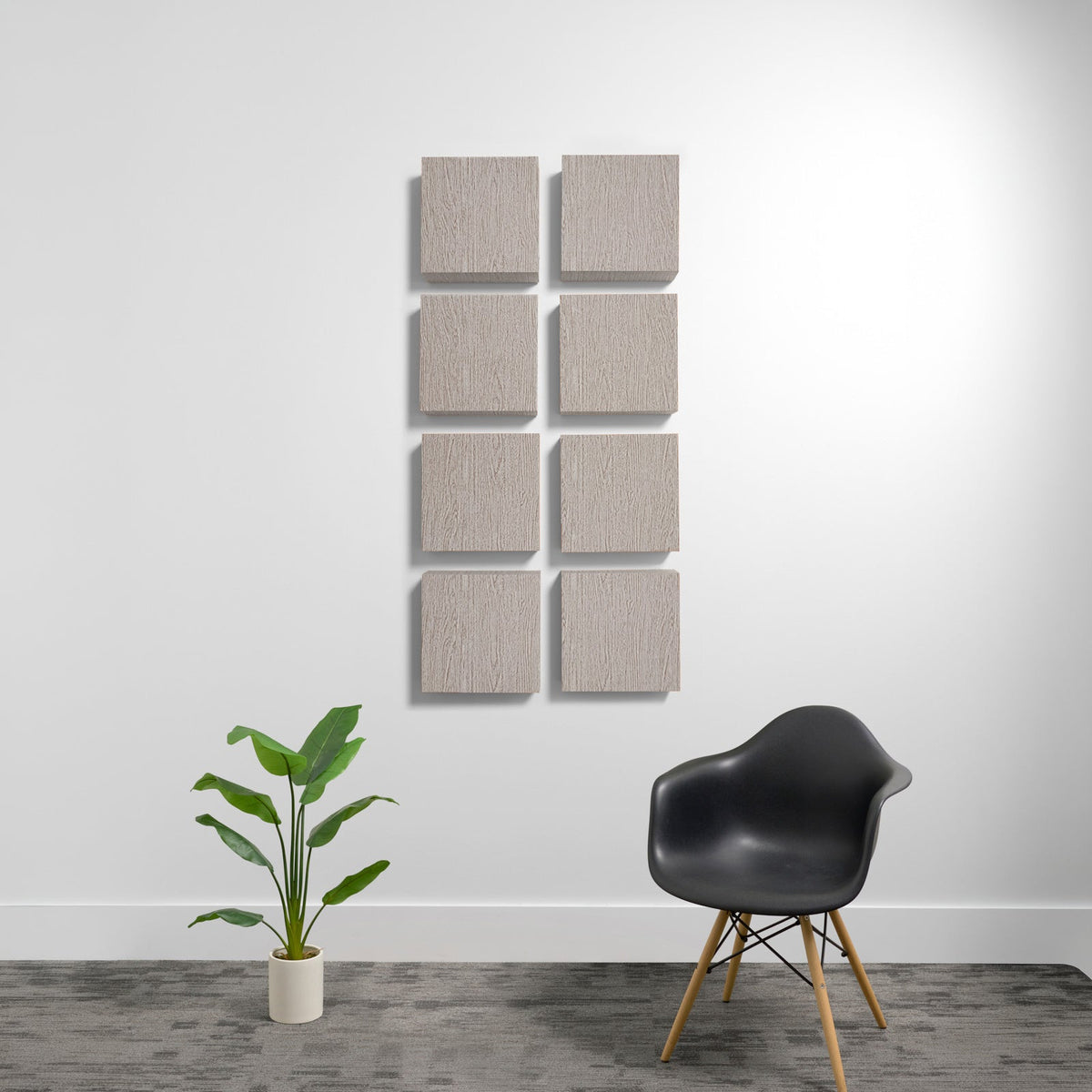 Eight square acoustic panels with textured light gray fabric surfaces arranged in a 2x4 grid on white wall.