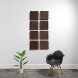 Eight square dark wood acoustic panels arranged in a 2x4 grid on a white wall.