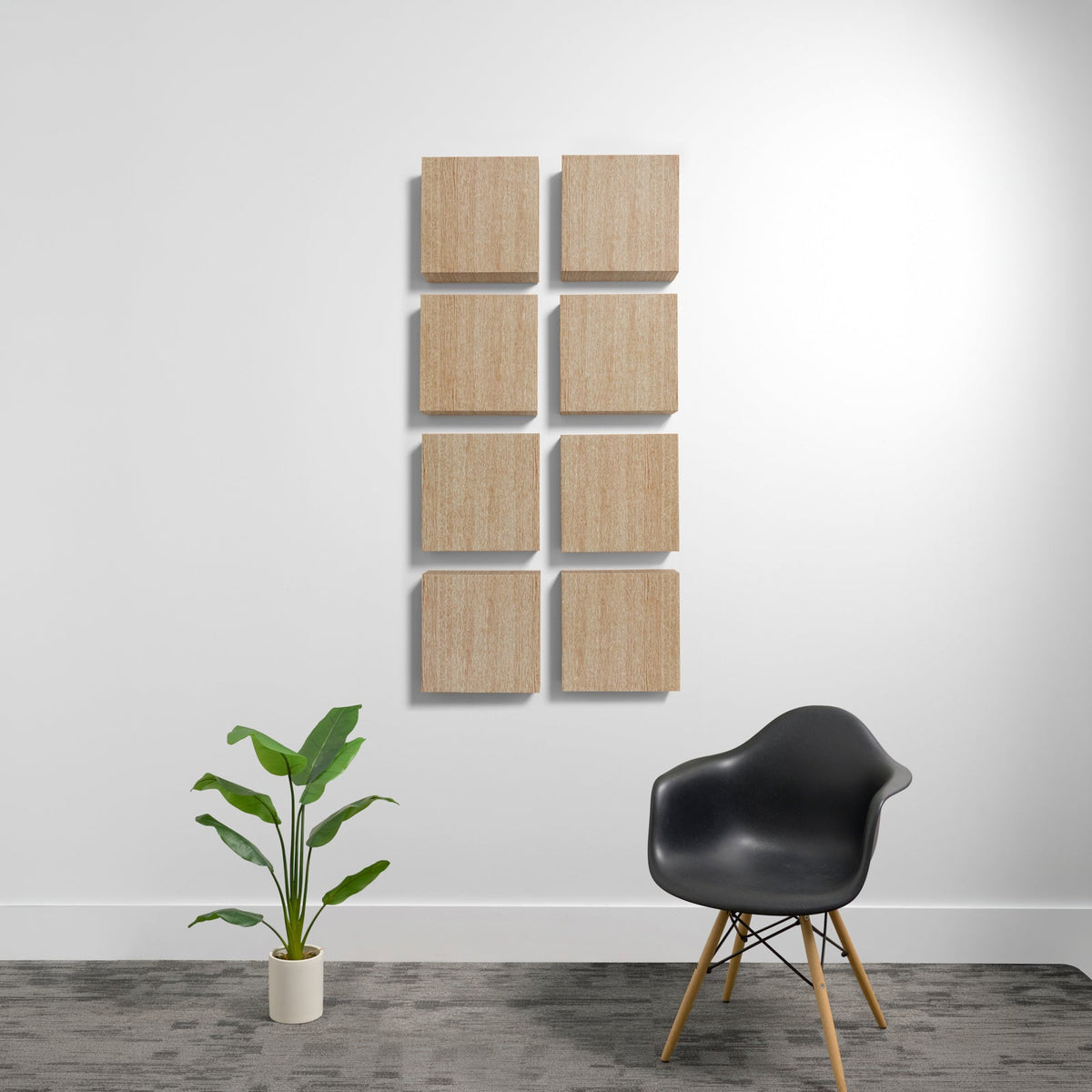 Eight square light wood acoustic panels arranged in a 2x4 grid on a white wall.