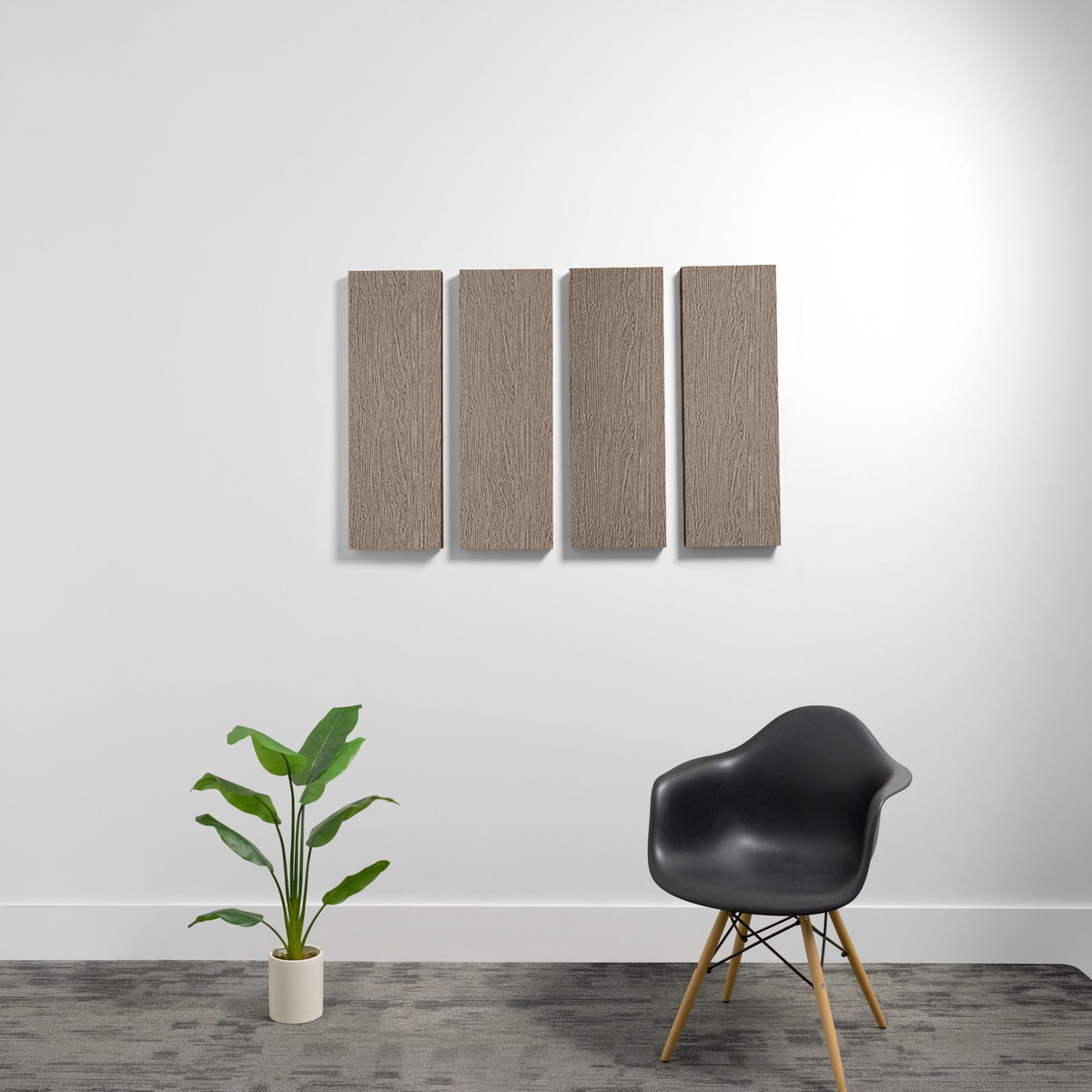 Four rectangular acoustic panels with textured brown fabric surface mounted on white wall.