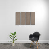 Four rectangular acoustic panels with textured brown fabric surface mounted on white wall.