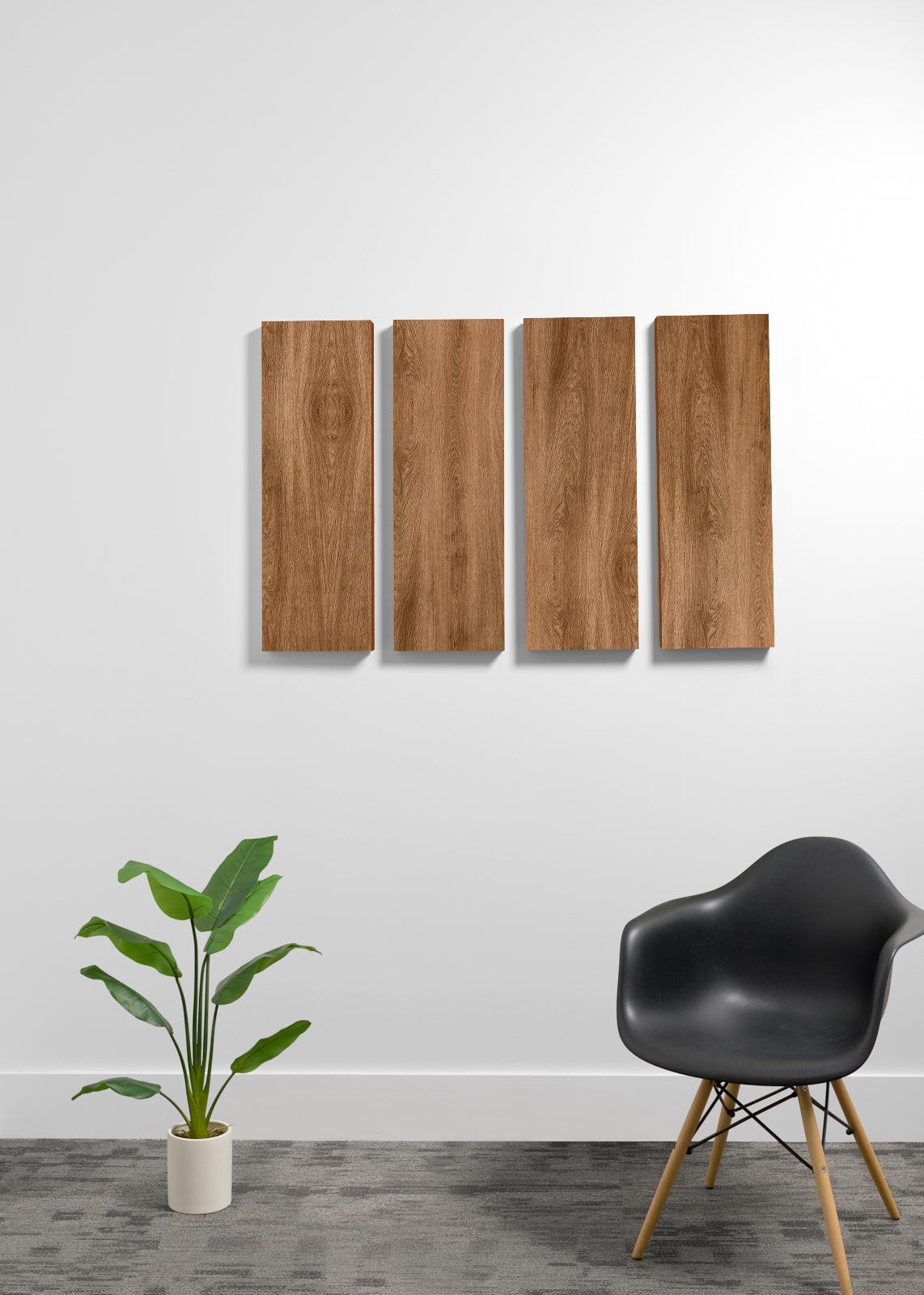 Four rectangular wall panels with a wood grain finish mounted on a white wall, styled in a modern room setting with a black chair and a potted plant.