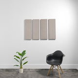 Four rectangular beige acoustic panels mounted vertically on a white wall.