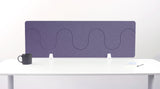 Purple desk divider with wavy cutout pattern mounted on white desk with white brackets.