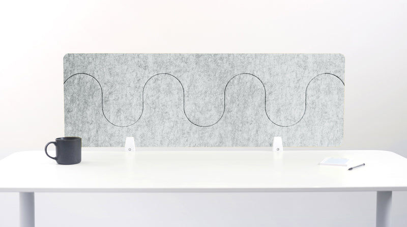 Gray office partition with wavy design on a white desk