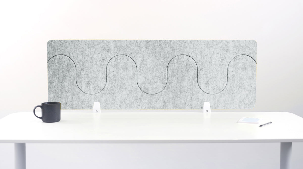 Gray office partition with wavy design on a white desk