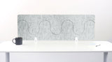 Gray office partition with wavy design on a white desk