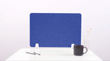 Blue desk divider with rounded corners mounted on white base, shown on white desk with pens and coffee mug.