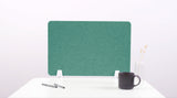 Green rectangular desk divider with rounded corners and white mounting brackets on white desk.