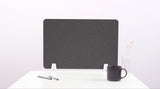 Dark gray desk divider with rounded corners mounted on white desk supports.