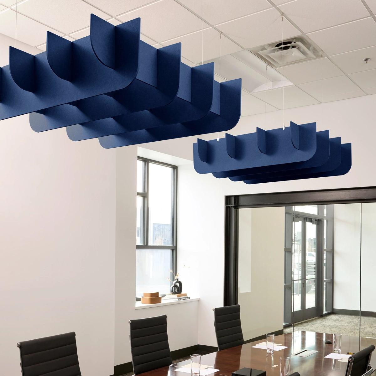 Fin 3D Cloud acoustic ceiling baffles in Admiral felt above a conference table