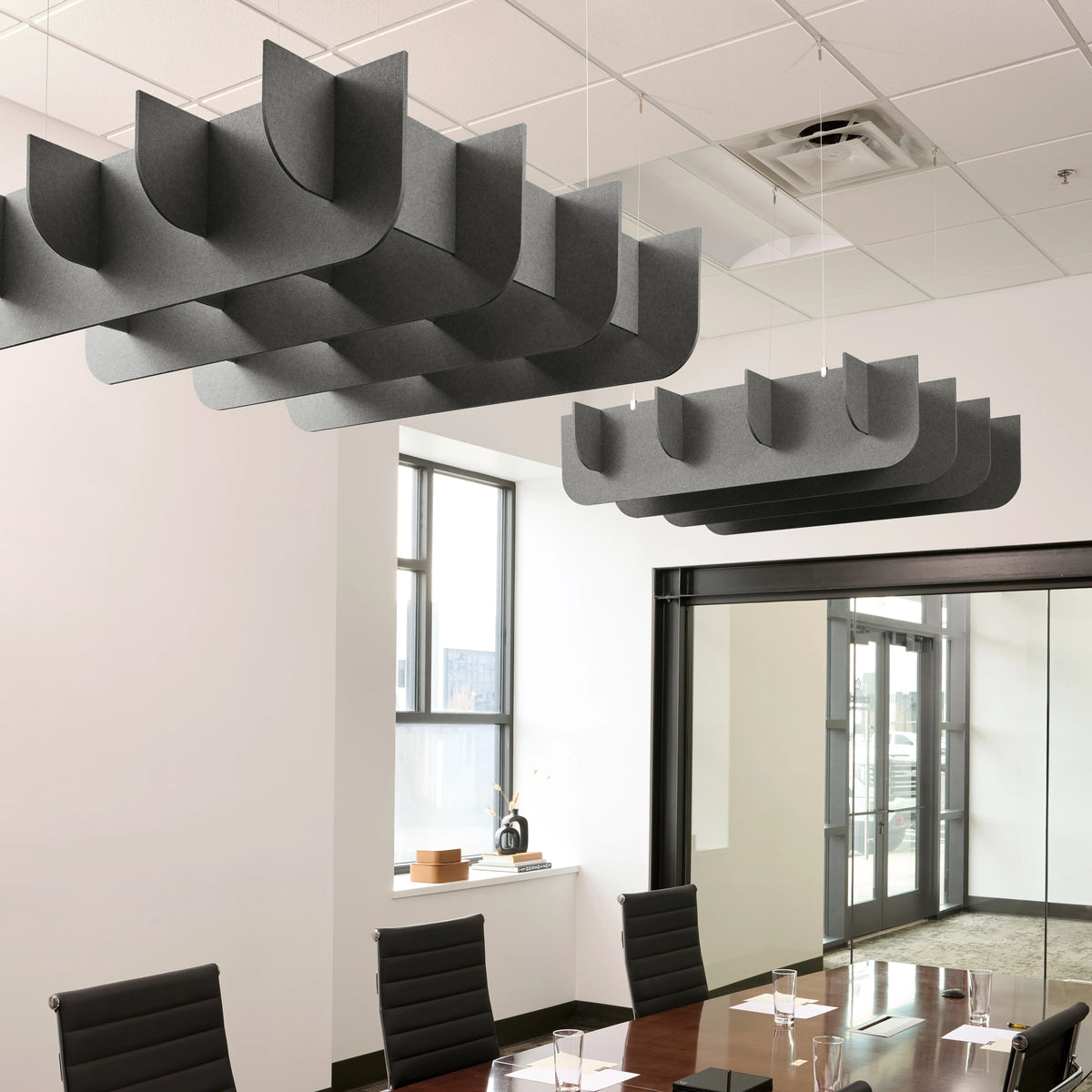 Fin 3D Cloud acoustic ceiling baffles in Armor felt above a conference table