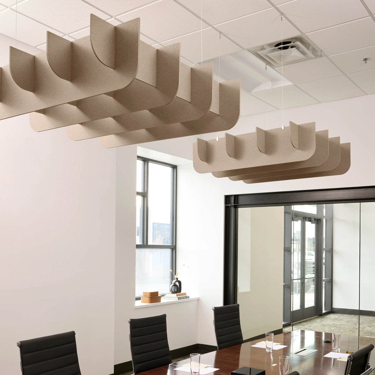 Fin 3D Cloud acoustic ceiling baffles in Cashmere felt above a conference table
