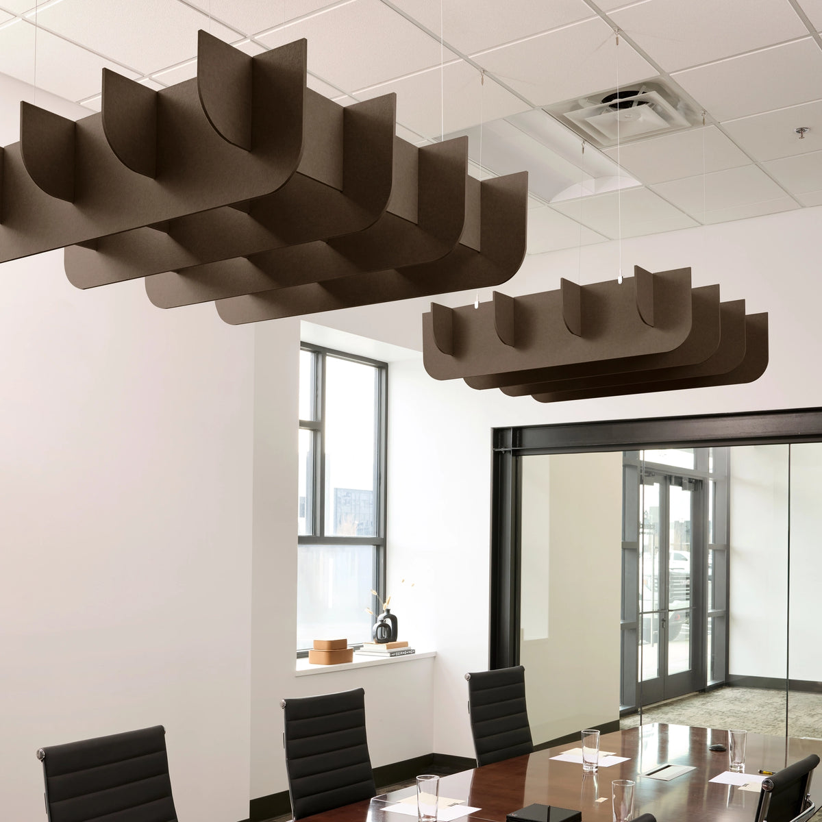 Fin 3D Cloud acoustic ceiling baffles in Cocoa felt above a conference table