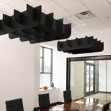 Fin 3D Cloud acoustic ceiling baffles in Ebony felt above a conference table