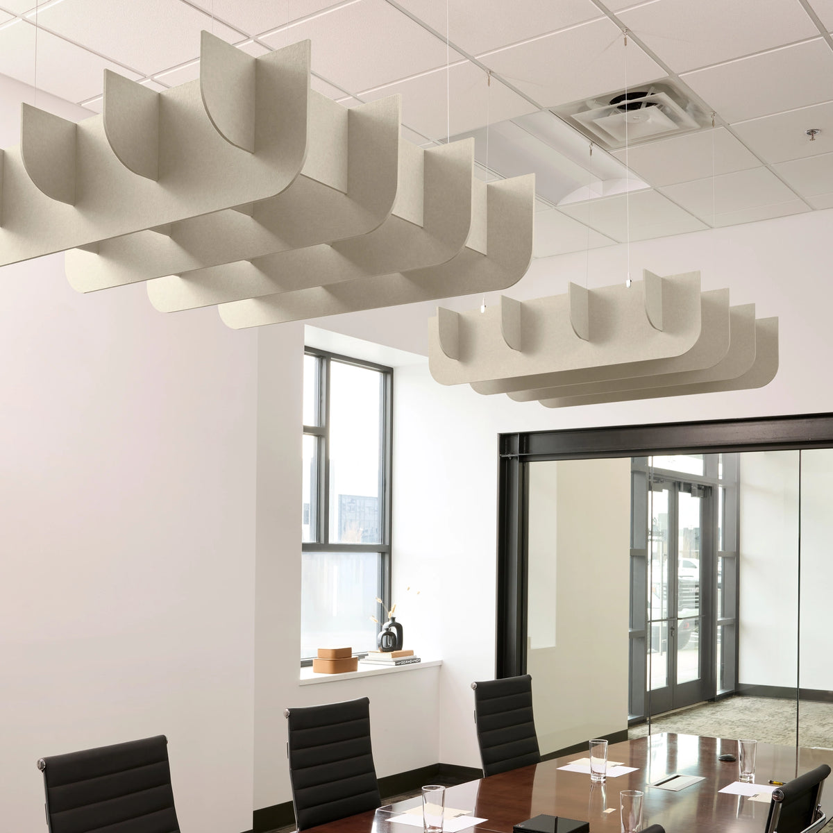 Fin 3D Cloud acoustic ceiling baffles in Ivory felt above a conference table