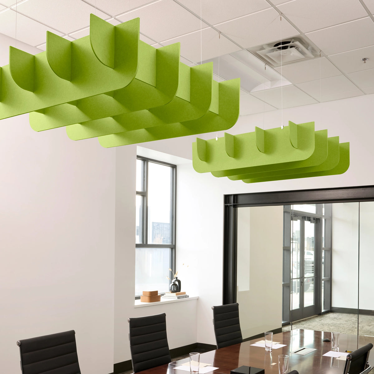 Fin 3D Cloud acoustic ceiling baffles in Kiwi felt above a conference table
