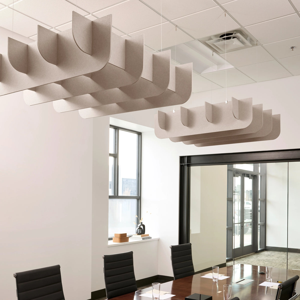 Fin 3D Cloud acoustic ceiling baffles in Latte felt above a conference table