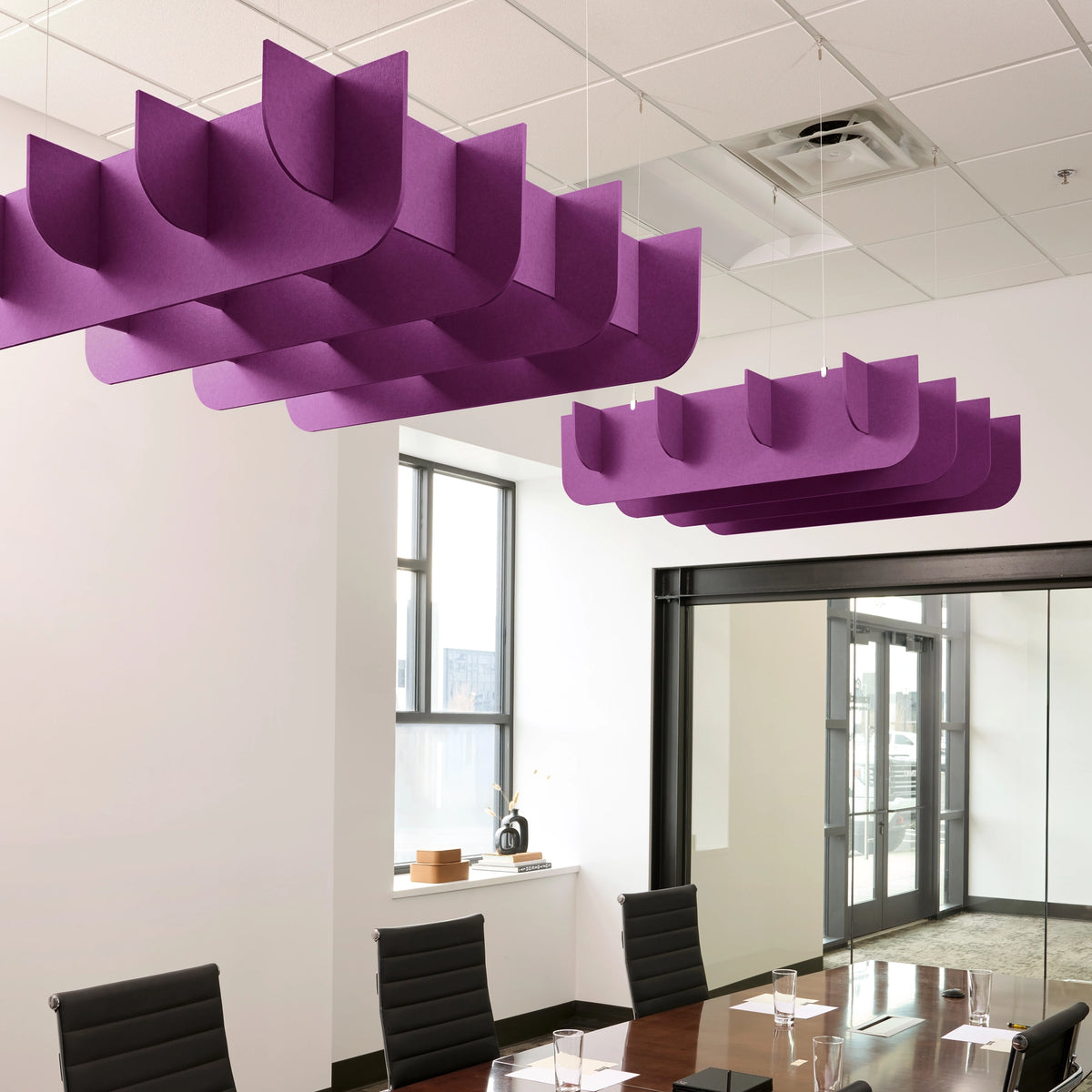 Fin 3D Cloud acoustic ceiling baffles in Lavender felt above a conference table