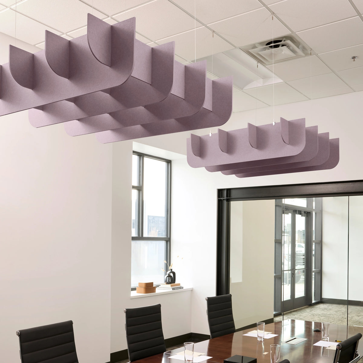 Fin 3D Cloud acoustic ceiling baffles in Lilac felt above a conference table