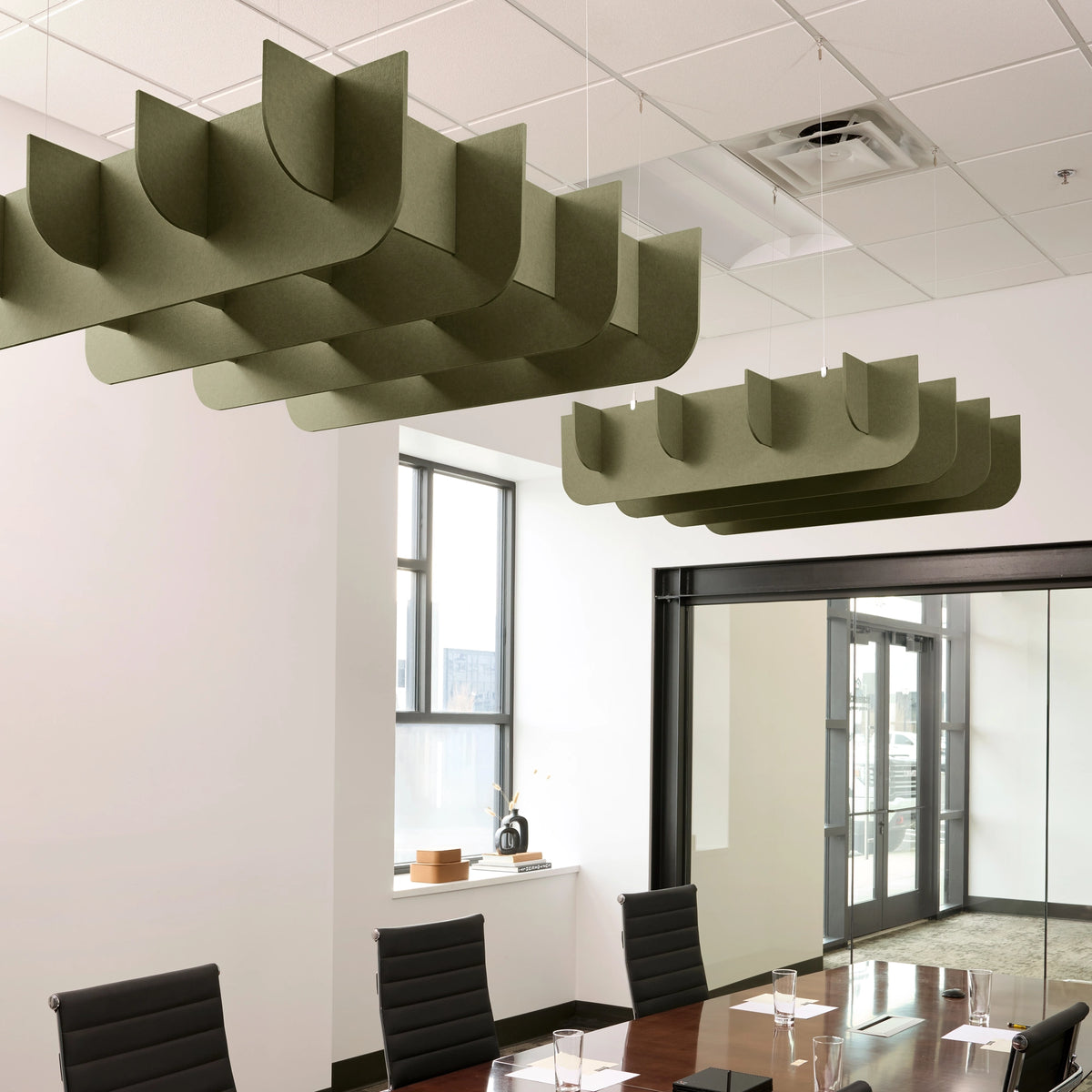 Fin 3D Cloud acoustic ceiling baffles in Olive felt above a conference table