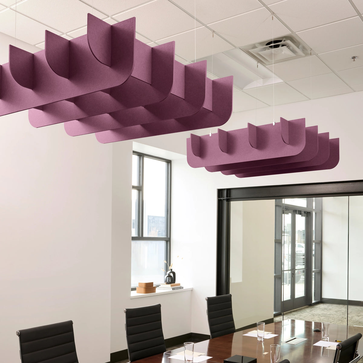 Fin 3D Cloud acoustic ceiling baffles in Plum felt above a conference table