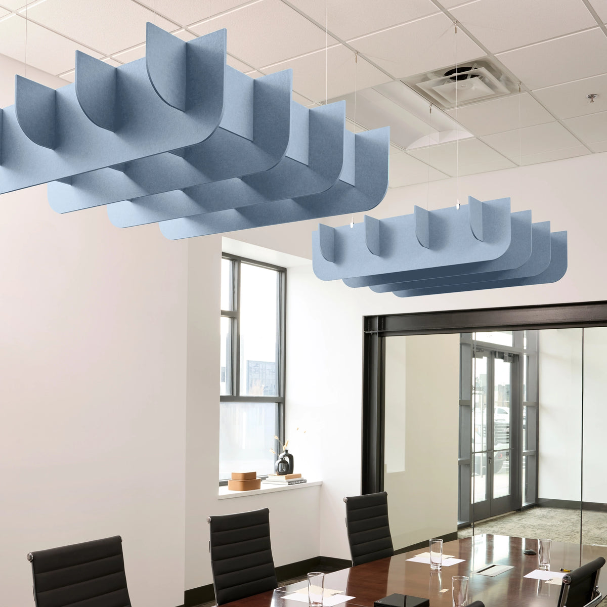 Fin 3D Cloud acoustic ceiling baffles in Powder Blue felt above a conference table