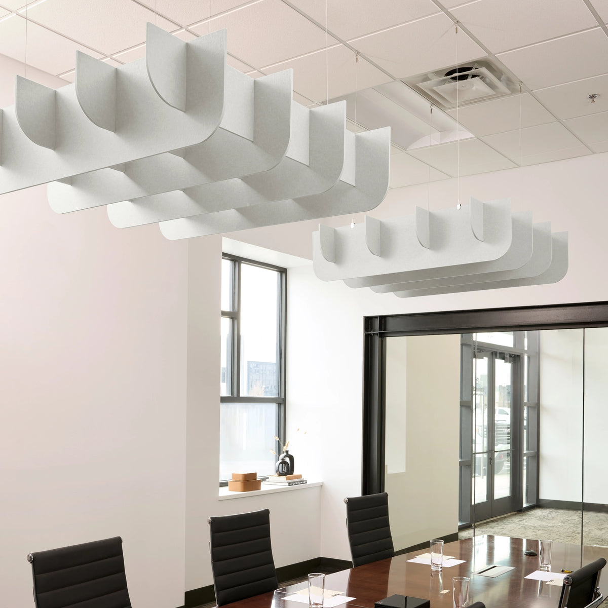 Fin 3D Cloud acoustic ceiling baffles in Zinc felt above a conference table